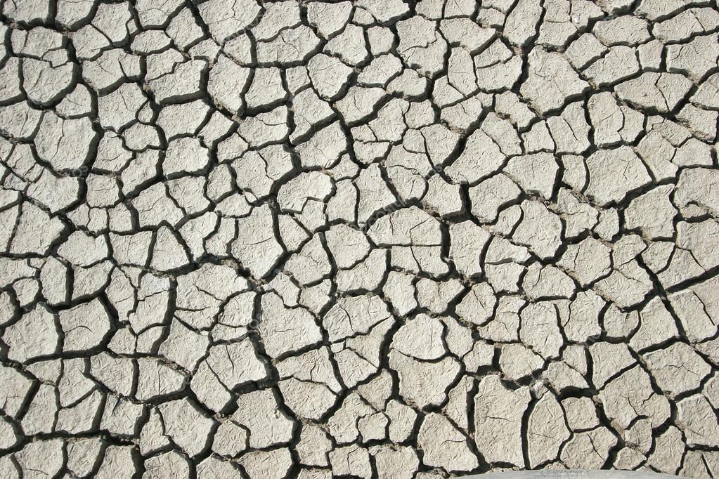 Arid soil texture Stock Photo by ©toucanet 77118921