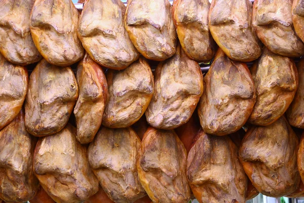 Rows hams hanging in market of Valencia