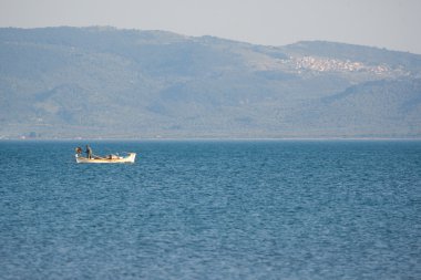 One little fishing boat in sea