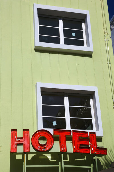 Neon hotel sign on building