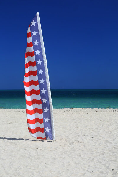 USA flag on sandy beach