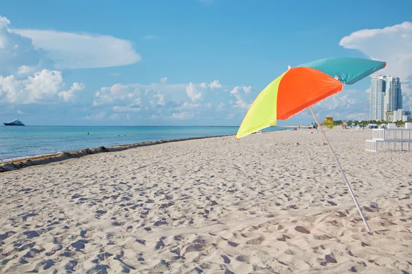 Multicolored parasol on the beach — Stock Photo, Image