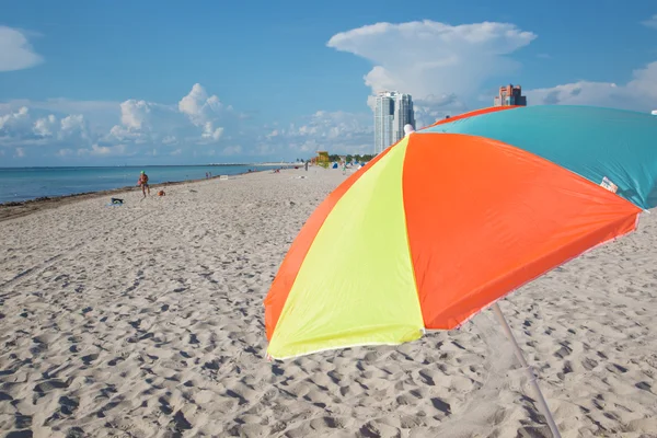 Multicolored parasol on the beach — Stock Photo, Image