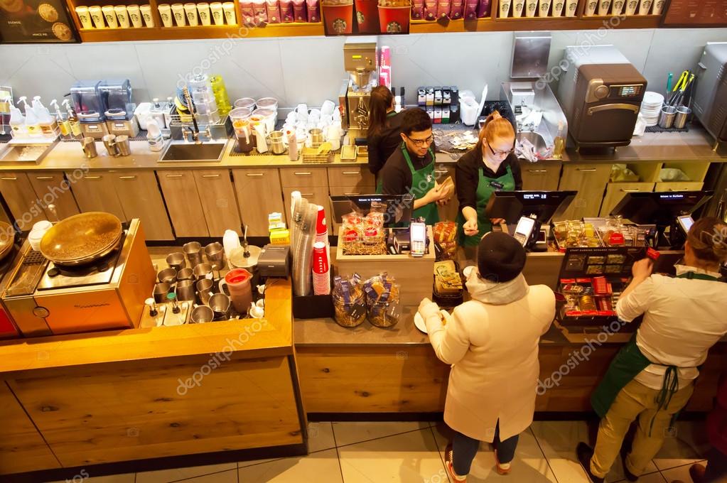 LONDON, ENGLAND - JANUARY 2016: People at the counter in London Starbucks