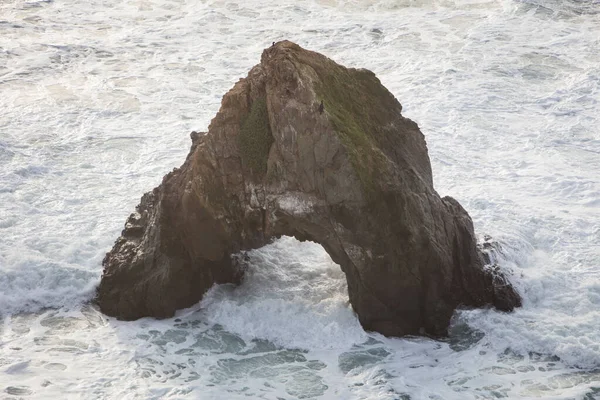 Cold waves from the Pacific Ocean beat against sea stacks just off the coast of Northern California in Mendocino. The scenic Pacific Coast Highway runs along this amazing part of the west coast.