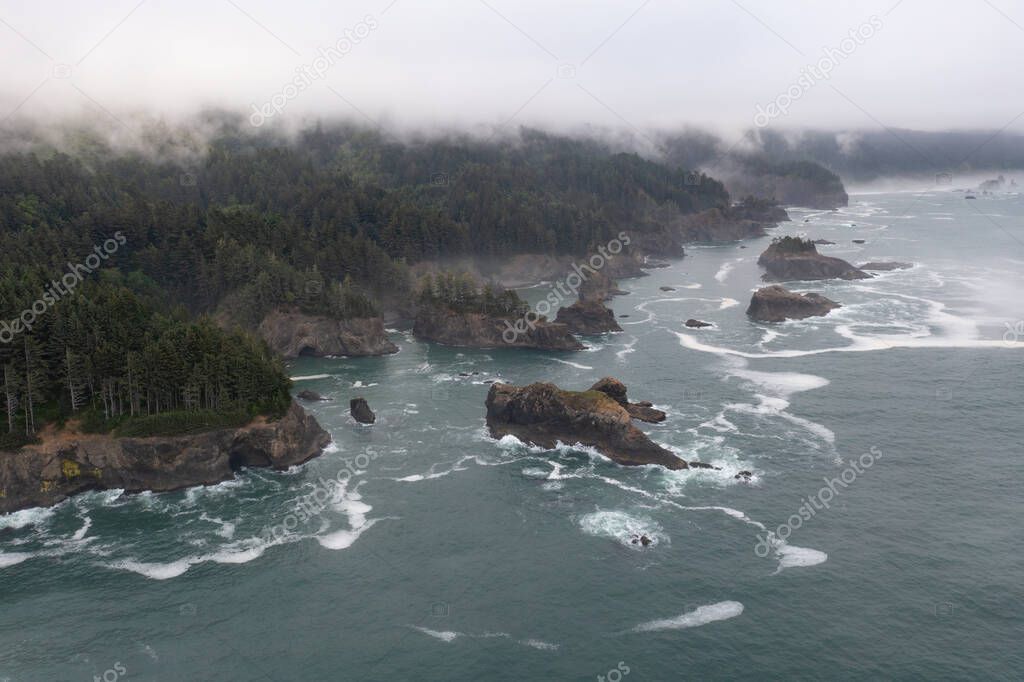 Fog drifts across the scenic coast of southern Oregon. This rugged and rocky part of the Pacific Northwest is found along the Samuel H. Boardman State Scenic Corridor.