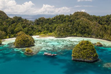 Raja Ampat surrounded by limestone islands clipart