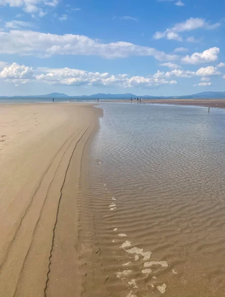 Irish Sea coast, low tide and sand bottom.