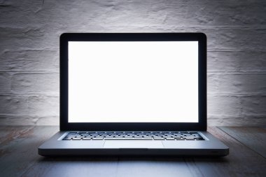 Geceleri dizüstü bilgisayarda beyaz ekran. Gecenin karanlığına kadar ev ofisinde..