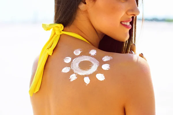 Woman With Suntan Lotion on her shoulder