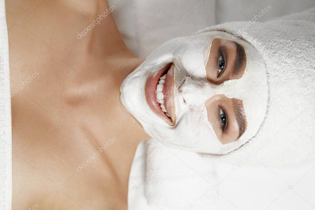 Beautiful woman with facial mask, spa treatment.Face peeling mask. skin care. 