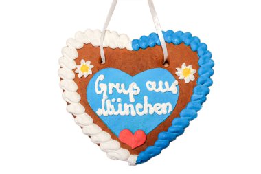 Gingerbread heart with written slogan: Greetings from Munich, Bavarian symbol and Munich landmark, Gingerbread candy isolated on white background, Bavaria Germany Europe clipart