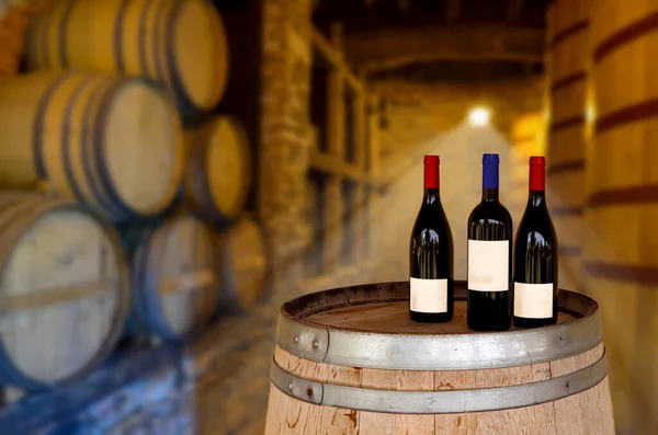 Red wine tasting in an old wine cellar with wooden wine barrels in a winery