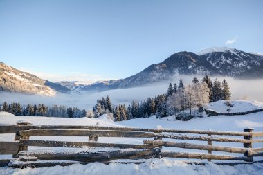 View to a winter landscape with wooden fence, Gasteinertal valley near Bad Gastein, Pongau Alps - Salzburg Austria Europe clipart