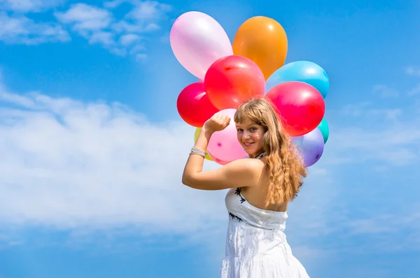 Happy young lady celebrates birthday with balloons — Stock Photo, Image