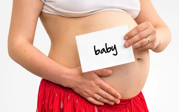 Беременная женщина с надписью: — стоковое фото