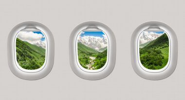 Looking out the windows of a plane to the mountains in Georgia clipart