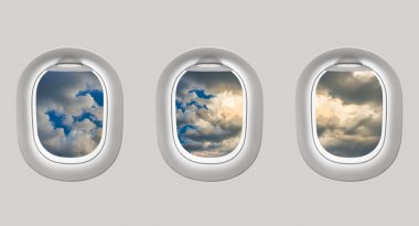 Looking out the windows of a plane to a blue sky and clouds clipart