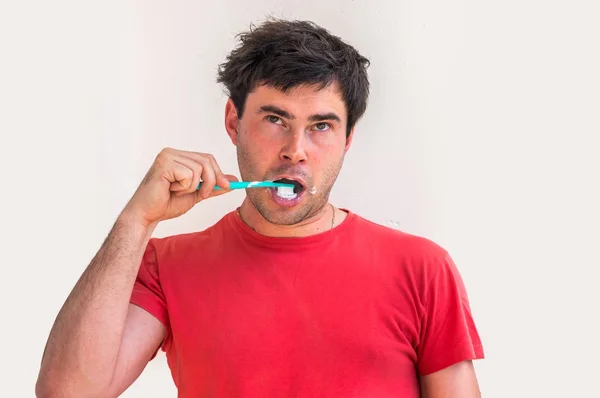 Young man brushing teeth in the morning — Stock Photo, Image