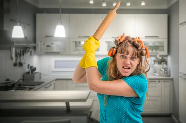 Mad and crazy housewife woman with kitchen roller — Stock Photo, Image