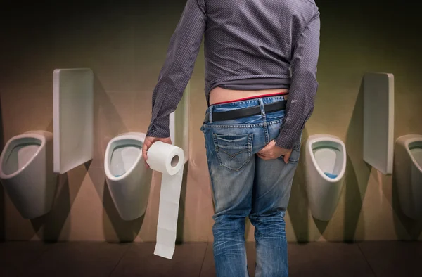 Man has diarrhea. Man holding toilet paper and butt. — Stock Photo, Image