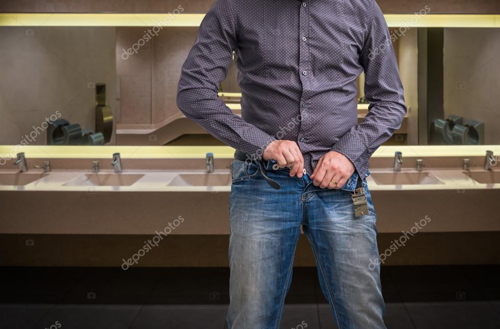 Man zip his pants up after peeing on the public toilet — Stock Photo