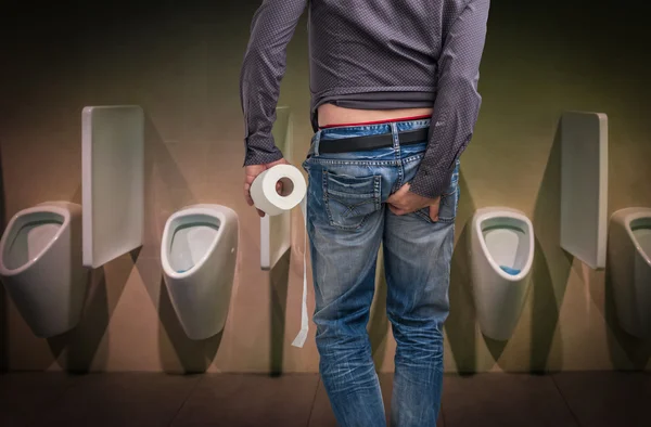 Man has diarrhea. Man holding toilet paper and butt. — Stock Photo, Image