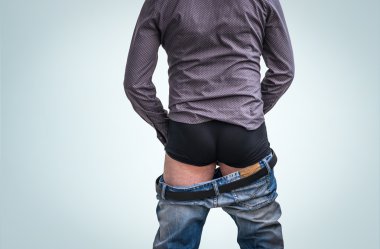 Standing man has undress jeans and peeing clipart