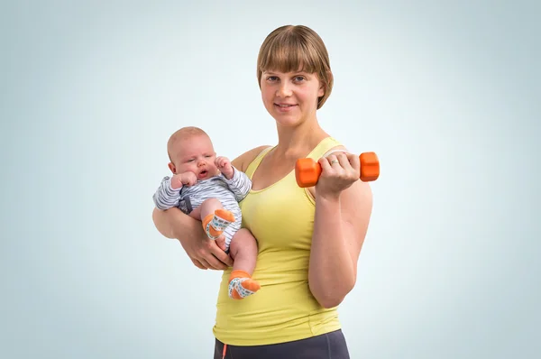 Woman strengthens with dumbbell after childbirth