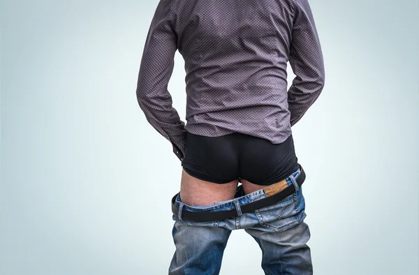 Standing man has undress jeans and peeing — Stock Image Standing man has undress jeans and peeing Royalty Free Stock Photos