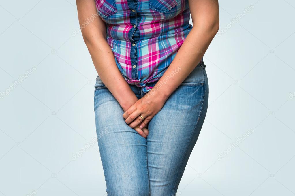 Woman with hands holding her crotch, she wants to pee