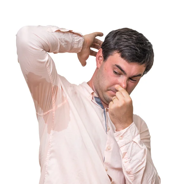 Man with sweating under armpit pinches nose with fingers — Stock Photo, Image