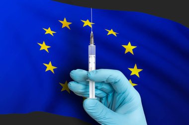 Avrupa Birliği 'nde aşı. Ulusal bayrağın arka planında Covid-19 'a karşı koruma aşısı.