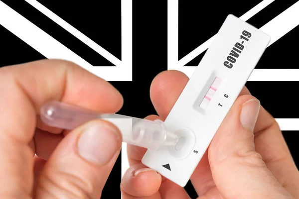 Positive rapid test on COVID-19 in United Kingdom on black and white background of national flag