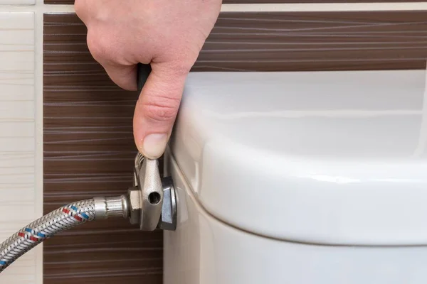 Plumber Repairing Toilet Cistern Using Wrench — Stock Photo, Image