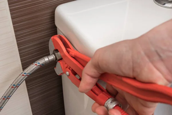 Plumber Repairing Toilet Cistern Using Wrench — Stock Photo, Image