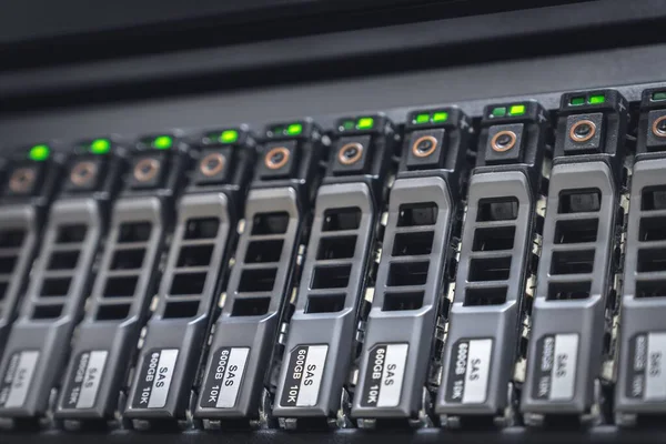Storage server with many HDD disks inside rack in server room - data center concept