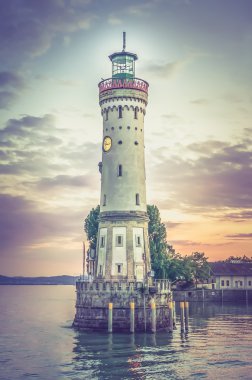 Mysterious lighthouse at evening in harbor of Lindau - retro and