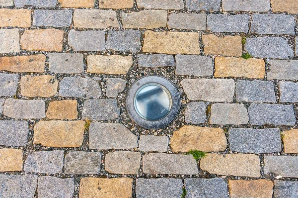 Cobblestone pavement on street with lighting — Stock fotografie