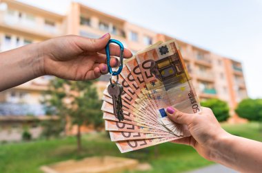 Real estate agent giving apartment keys to a new property owner,