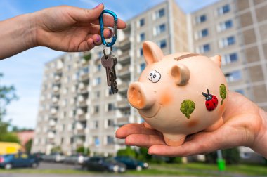 Real estate agent giving flat keys to a new property owner, who 