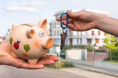 Real estate agent giving house keys to a new property owner, who