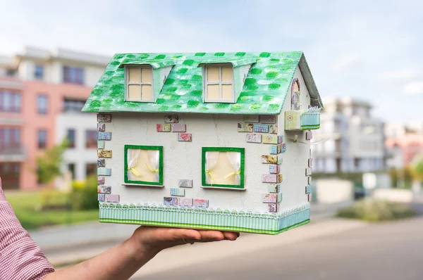 Real estate agent holding model house from paper — Stock Photo, Image