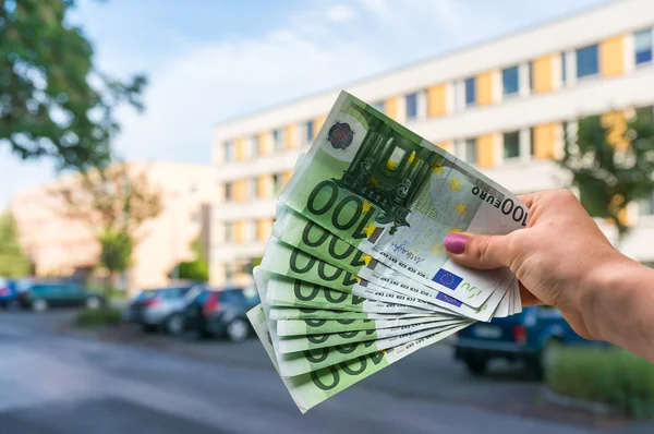 Property buyer holding euro banknotes and buying beautiful flat