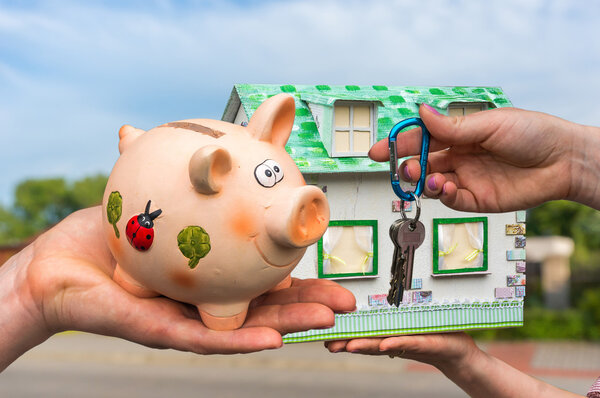 Real estate agent giving house keys to a new property owner, who