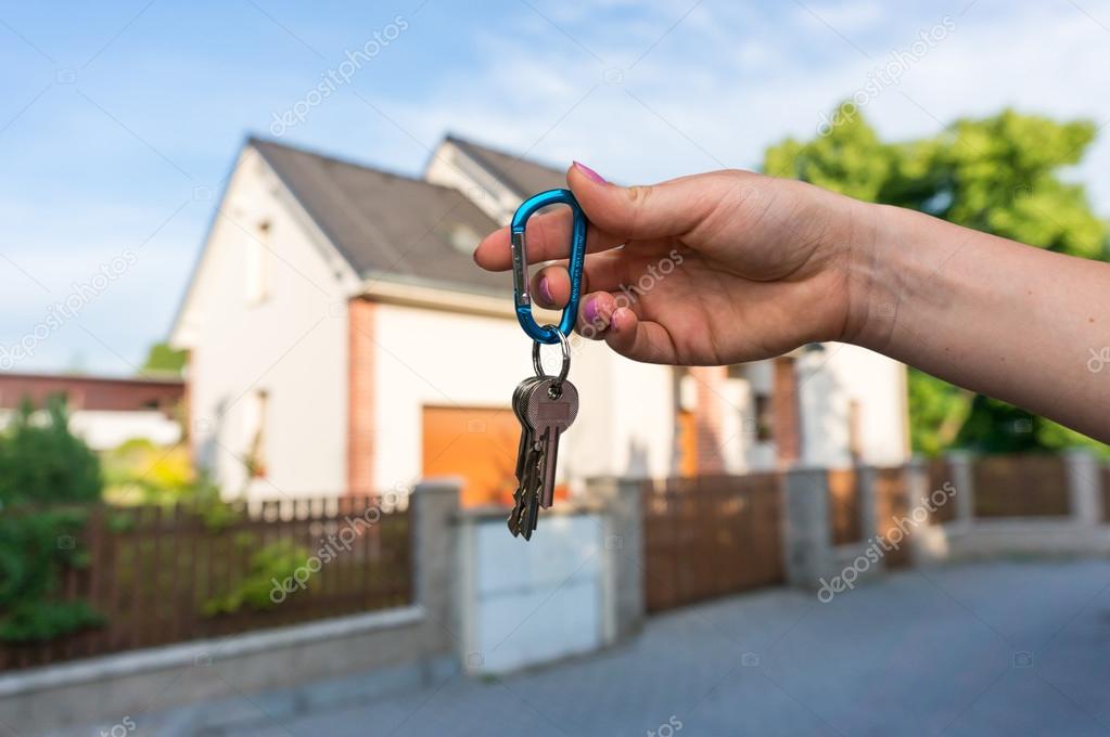 Real estate agent giving house keys to a new property owner
