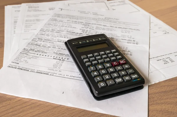 Calculator over a bank financial statement — Stok fotoğraf