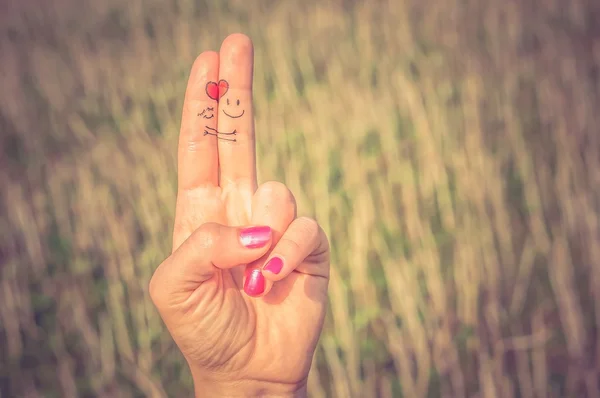 Fingers in love with painted smiley — Stock Photo, Image