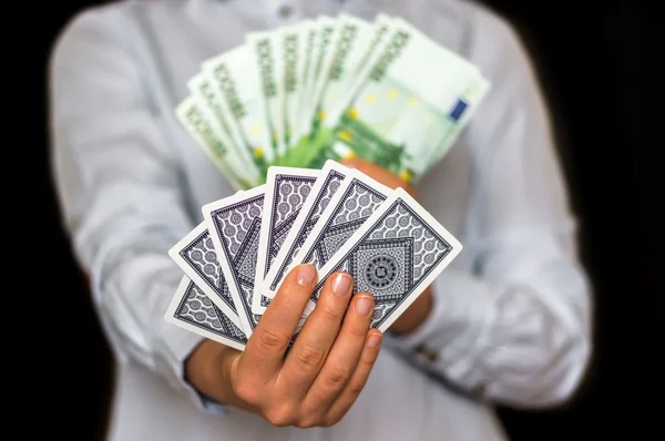 Gambler with cards and euro money banknotes — 스톡 사진