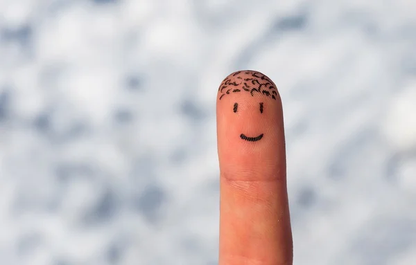 Happy finger on a snow background — Stockfoto